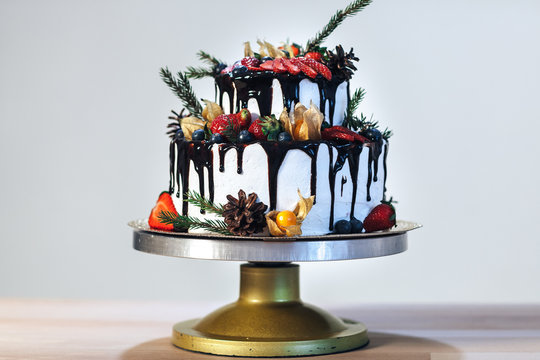 White Cream Icing Cake with Fruits and Chocolate, Wedding naked cake on white background, side view