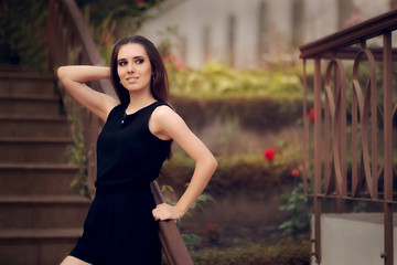 Elegant Woman Wearing Black Dress Standing in a Patio