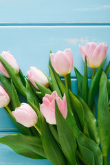 Tulips on blue wood background, copy space