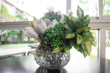 Decoration artificial flower on wood table