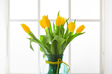 Flowers background, yellow tulips at window background, copy space