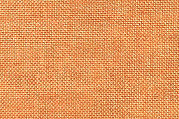 Orange textile background closeup. Structure of the fabric macro