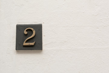 House number 2 sign on wall