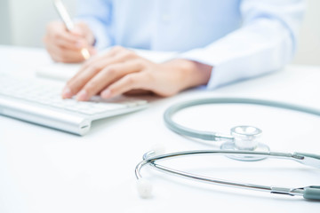 Docter and stethoscope on white table