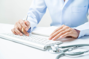 Docter and stethoscope on white table