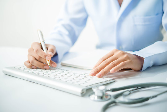 Docter and stethoscope on white table