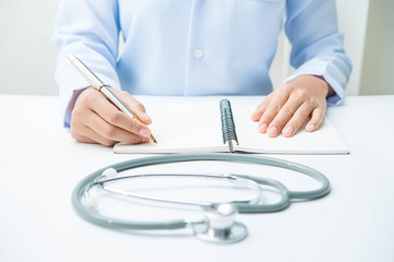 Docter and stethoscope on white table