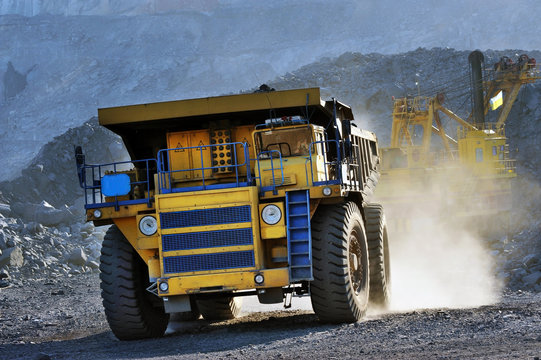 Heavy dump truck carrying the iron ore on the opencast mining