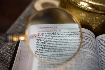 Reading the Bible with magnify glass 1 Corinthians 13  - 150892065