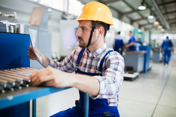 Supervisor doing quality control and pruduction check in factory