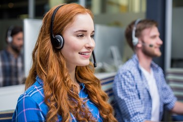 Smiling female customer service executive talking 
