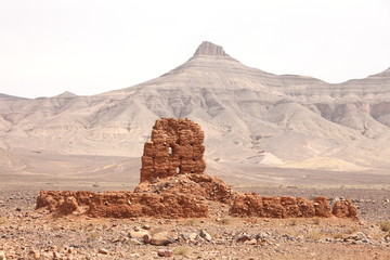 Fototapeta na wymiar Ruins of clay building near Atlas mountains, Morocco