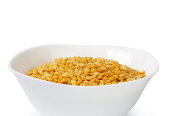 Dry yellow split peas isolated on white.