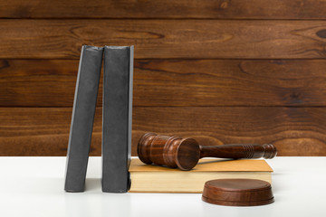 Wooden gavel and books on wooden table