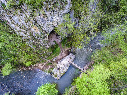 Varghisului Gorges in Covasna and Harghita county, Transylvania, Romania. Entrance to one of the caves visible. Aerial view from a drone.