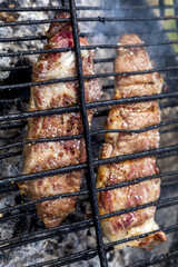 Iberian pork meat grilling on the barbecue - Secreto y Pluma iberico