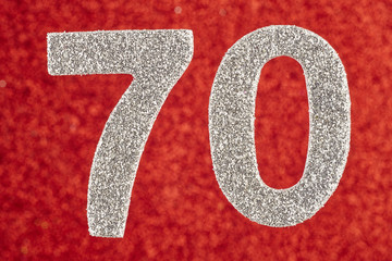 Number seventy silver color over a red background. Anniversary.