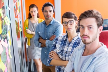 Portrait of executives standing with arms crossed
