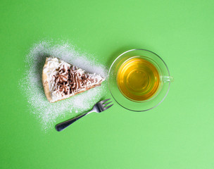 cake with tea on green background