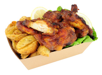 Chicken wings and potato wedges in a cardboard take away tray isolated on a white background