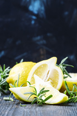 Fresh rosemary and lime, dark wooden background, selective focus