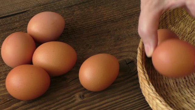 Brown egg in a basket on wooden table, chicken egg
