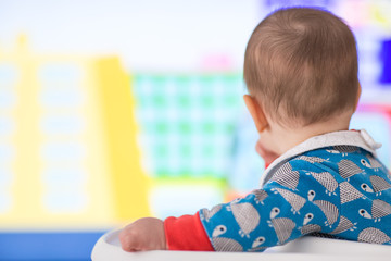 Baby watching cartoons on TV (6 months old).