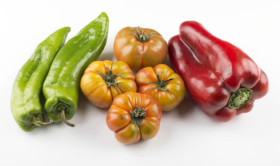 Appetizing tomatoes and red pepper on white background. Isolated.