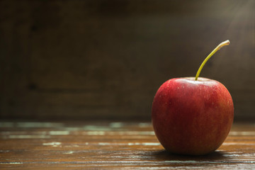 single red apple on wooden background