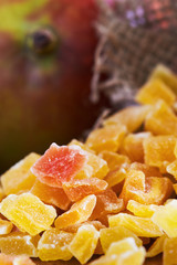 Closeup of dried and candied mango on wooden background
