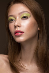 Obraz premium Beautiful red-hair girl with creative green makeup. Beauty face. Photos shot in studio