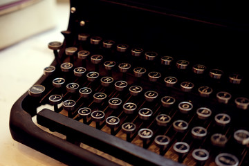 Old fashioned iron typewriter console closeup in black