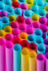 Closeup image of pastel colored straws on black background