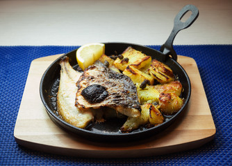 Pieces of Fish and Potato in Pan