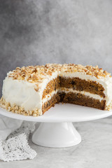 homemade carrot cake with cream cheese frosting and nuts