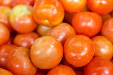 red tomatoes display at fresh market stall background