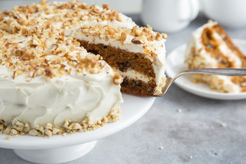 carrot cake with cream cheese frosting and nuts - Powered by Adobe