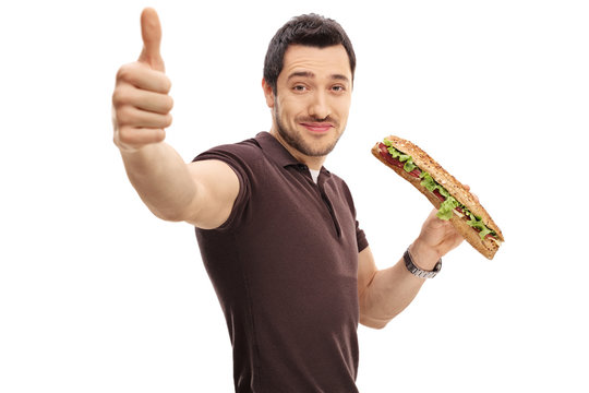 Young Man With A Sandwich Making A Thumb Up Sign