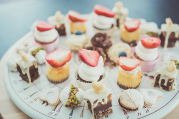Dessert bar with delicious cake pops and different sweets on a plate