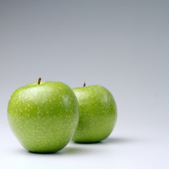 Green apples on a white background