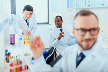 young doctors in uniform working at testing laboratory, laboratory technicians