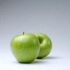 Green apples on a white background