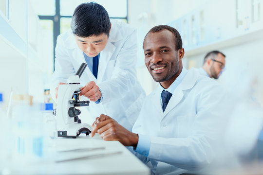 young doctors in uniform working at testing laboratory, laboratory technicians