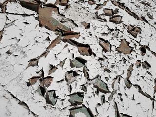 White paint peeling off exterior wall