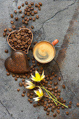 Coffee cup and coffee beans on a gray background. Top view.