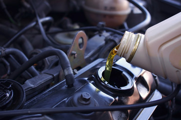 Motor oil pouring to car engine. Crude oil prices and gas price. Oil Prices Move Higher, business...