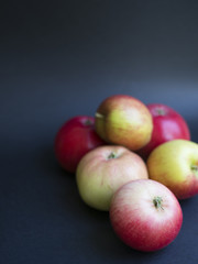 Fresh Danish autumn apples in a pile isolated on black background