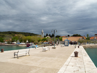 Obraz premium Town pier in Zlarin island in Croatia, port marine with yachts and catamarans