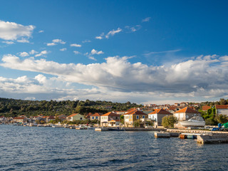 Fototapeta na wymiar Kaprije island in Croatia, Mediterranean sea village and marine port during sunset 