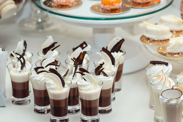 rows of chocolate italian mignon cakes on a white table